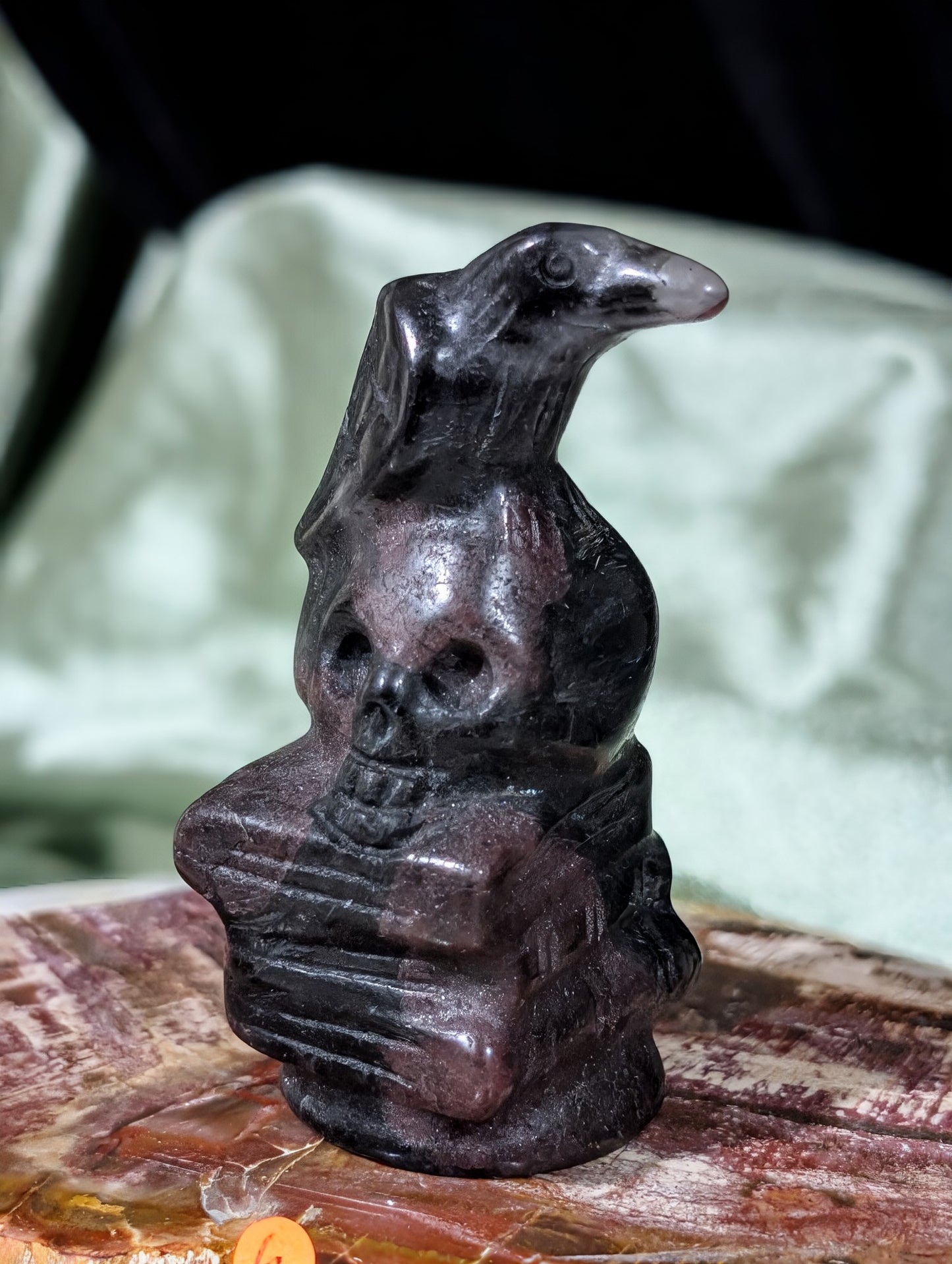 Garnet Raven on Skull on Books Figurine